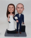 Travel themed wedding bobblehead cake toppers